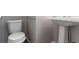 Powder room with a pedestal sink and modern toilet at 3470 River Mill Ln, Ellenwood, GA 30294
