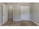 Bedroom features neutral walls, plush carpeting, and closet with bi-fold doors at 3470 River Mill Ln, Ellenwood, GA 30294
