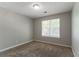 Cozy bedroom with neutral walls, plush carpeting, and a window allowing natural light at 3470 River Mill Ln, Ellenwood, GA 30294