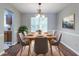 Bright dining room features wood floors, modern lighting, and a large window at 3470 River Mill Ln, Ellenwood, GA 30294