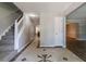 Entryway features gray walls, tile flooring, staircase and flows into the dining and living rooms at 3470 River Mill Ln, Ellenwood, GA 30294