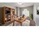 Staged home office with large desk, chair, bookshelf, and natural light at 3470 River Mill Ln, Ellenwood, GA 30294