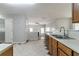 Kitchen features a stainless steel refrigerator, wood cabinets, and a view into the living room at 3470 River Mill Ln, Ellenwood, GA 30294