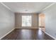 Bright living room with wood floors and natural light from large window at 3470 River Mill Ln, Ellenwood, GA 30294