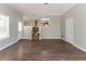 Open-concept living room with hardwood floors flows into the kitchen area at 3470 River Mill Ln, Ellenwood, GA 30294
