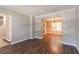 Open-concept space with hardwood floors seamlessly connects living and dining areas at 3470 River Mill Ln, Ellenwood, GA 30294