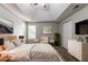 This main bedroom features a tray ceiling, large windows, and modern furniture at 3470 River Mill Ln, Ellenwood, GA 30294