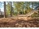 Large backyard with mature trees provides shade and privacy at 4711 Oakleigh Manor Dr, Powder Springs, GA 30127