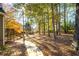 Beautiful backyard features mature trees, lush landscaping, and a private setting at 4711 Oakleigh Manor Dr, Powder Springs, GA 30127