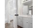 Bathroom with double sink vanity, white cabinets and chrome hardware at 4711 Oakleigh Manor Dr, Powder Springs, GA 30127