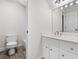 Bathroom featuring a toilet, shower with glass door, sink with a vanity and a mirror at 4711 Oakleigh Manor Dr, Powder Springs, GA 30127