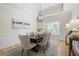 Elegant dining room with stylish lighting, neutral colors, and ample seating for dinner parties at 4711 Oakleigh Manor Dr, Powder Springs, GA 30127