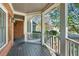 Exterior view showcasing a covered porch with white railings and brick pillars at 4711 Oakleigh Manor Dr, Powder Springs, GA 30127