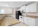 Kitchen features white cabinets, stainless steel appliances, and light countertops at 4711 Oakleigh Manor Dr, Powder Springs, GA 30127
