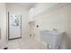 Practical laundry room with utility sink, cabinet, and door to the backyard at 4711 Oakleigh Manor Dr, Powder Springs, GA 30127