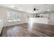 Living room featuring wood floors, bright windows, and a partial view of the kitchen at 4711 Oakleigh Manor Dr, Powder Springs, GA 30127