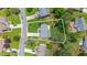 Aerial view of a lovely landscaped yard with mature trees, and neighboring homes showing property outline at 8045 Depford Way, Cumming, GA 30041