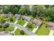 Beautiful aerial view of homes with lush landscaping and sidewalks in a quiet residential neighborhood at 8045 Depford Way, Cumming, GA 30041