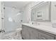 Modern bathroom with glass shower, gray vanity with undermount sink and brushed nickel faucet, and marble tile floor at 8045 Depford Way, Cumming, GA 30041