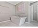 Luxurious bathroom featuring a freestanding soaking tub and clean, modern design at 8045 Depford Way, Cumming, GA 30041