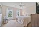 Cozy bedroom with two windows, neutral carpet, ceiling fan and furniture is filled with natural light at 8045 Depford Way, Cumming, GA 30041