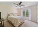 This charming bedroom features a ceiling fan, plush carpeting, and a large window with natural light at 8045 Depford Way, Cumming, GA 30041