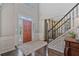 Elegant entryway with hardwood floors, high ceilings, and staircase with iron railing at 8045 Depford Way, Cumming, GA 30041