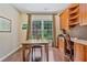 Bright home office with custom built-ins, hardwood floors, and large window at 8045 Depford Way, Cumming, GA 30041