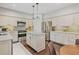 Well-equipped kitchen with stainless appliances, a center island, granite countertops, and ample cabinet space at 8045 Depford Way, Cumming, GA 30041