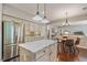Kitchen with a center island, stainless refrigerator, granite counters and view to the breakfast table at 8045 Depford Way, Cumming, GA 30041
