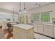 Open-concept kitchen featuring a center island, stainless appliances, and view to the living room at 8045 Depford Way, Cumming, GA 30041