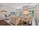 Comfortable living room with neutral decor, fireplace, large windows, and a TV for entertainment at 8045 Depford Way, Cumming, GA 30041