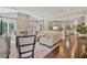 Inviting living room with stone fireplace, hardwood floors, and an open view to the adjacent kitchen at 8045 Depford Way, Cumming, GA 30041