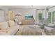 Cozy living room featuring a neutral color scheme, soft seating, and a large window for natural light at 8045 Depford Way, Cumming, GA 30041