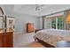 Relaxing main bedroom with a tray ceiling, patterned bedding, and a dresser with ample storage at 8045 Depford Way, Cumming, GA 30041