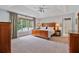 Spacious main bedroom with a tray ceiling, large window, and elegant wood furniture at 8045 Depford Way, Cumming, GA 30041