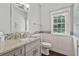 Stylish powder room with granite countertop, modern fixtures, and decorative tile at 8045 Depford Way, Cumming, GA 30041