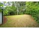 Expansive backyard with lush green grass and mature trees, offering a private outdoor retreat at 1111 Edgefield Sw Dr, Atlanta, GA 30310