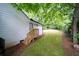 A quaint white house features a sloped backyard with lush greenery, offering a serene outdoor space at 1111 Edgefield Sw Dr, Atlanta, GA 30310