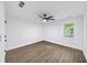 Bright, airy bedroom showcasing sleek floors, ceiling fan, and neutral walls complemented by a sunny window at 1111 Edgefield Sw Dr, Atlanta, GA 30310