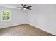 This bedroom is bright and has new floors, ceiling fan, white walls and is complimented by a sunny window at 1111 Edgefield Sw Dr, Atlanta, GA 30310