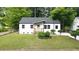 Beautiful renovated home with modern windows, gray roof, white siding, and a well-manicured lawn at 1111 Edgefield Sw Dr, Atlanta, GA 30310