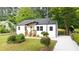 Charming renovated home with new landscaping, gray roof, white siding, and an inviting front porch at 1111 Edgefield Sw Dr, Atlanta, GA 30310