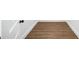 Hallway features modern flooring, white trim, and new door with a black knob at 1111 Edgefield Sw Dr, Atlanta, GA 30310