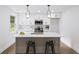 Well-lit kitchen features an island with bar seating, quartz countertops, and modern stainless steel appliances at 1111 Edgefield Sw Dr, Atlanta, GA 30310