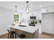Modern kitchen with stainless steel appliances, island seating, white cabinetry, and hardwood flooring at 1111 Edgefield Sw Dr, Atlanta, GA 30310