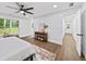 Spacious main bedroom featuring modern decor, a ceiling fan, and a seamless transition to the en-suite bathroom at 1111 Edgefield Sw Dr, Atlanta, GA 30310