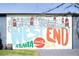 A colorful mural celebrating the West End neighborhood in Atlanta, featuring houses and Coca-Cola imagery at 1111 Edgefield Sw Dr, Atlanta, GA 30310