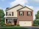 Two-story home showcasing a brick and siding facade, complemented by dark shutters and a two-car garage at 308 Oak View Ln, Dallas, GA 30157