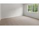 Bedroom featuring neutral carpet, light walls, and a bright window at 408 Oak View Ln, Dallas, GA 30157